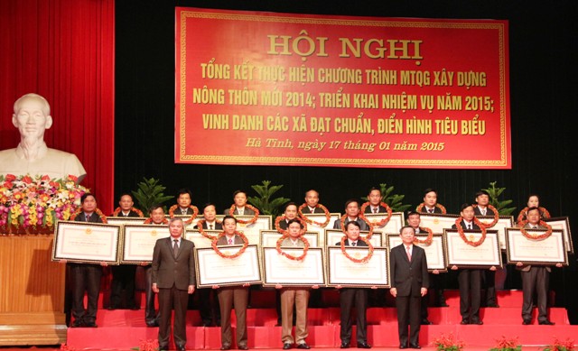 Phó Bí thư Thường trực Tỉnh ủy Trần Nam Hồng và Chủ tịch UBND tỉnh Võ Kim Cự trao bằng công nhận đạt chuẩn NTM năm 2014 cho 19 xã